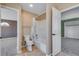 Bathroom featuring a toilet, shower-tub combo, and entry to another room at 9239 Erminedale Dr, Lone Tree, CO 80124