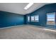 Large bedroom with an abundance of natural light from windows, grey carpet, and high, vaulted ceiling at 9239 Erminedale Dr, Lone Tree, CO 80124