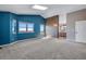 Spacious primary bedroom featuring blue accent wall, skylight, windows with views and ensuite bathroom access at 9239 Erminedale Dr, Lone Tree, CO 80124