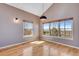 Serene bedroom with hardwood floors and scenic views from multiple windows at 9239 Erminedale Dr, Lone Tree, CO 80124