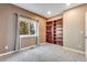 Cozy bedroom with a window providing natural light and a built-in wooden bookshelf against a painted wall at 9239 Erminedale Dr, Lone Tree, CO 80124