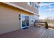 Back deck featuring wood decking, railing, and access to the home through sliding glass doors at 9239 Erminedale Dr, Lone Tree, CO 80124