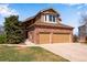 Charming brick home with a two-car garage and well-maintained lawn at 9239 Erminedale Dr, Lone Tree, CO 80124