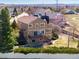 Exterior view of the home featuring a deck, back yard, and upper and lower patios at 9239 Erminedale Dr, Lone Tree, CO 80124