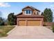 Charming brick home with a two-car garage and well-maintained lawn at 9239 Erminedale Dr, Lone Tree, CO 80124