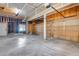 Spacious garage with concrete floor, wood framing and two overhead doors at 9239 Erminedale Dr, Lone Tree, CO 80124