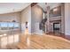 Open living room with hardwood floors, grand staircase, and scenic views at 9239 Erminedale Dr, Lone Tree, CO 80124