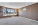 Bright living room with large window providing natural light and neutral carpet at 9239 Erminedale Dr, Lone Tree, CO 80124