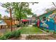Landscaped backyard featuring artificial turf, a patio, and a whimsical mural at 1341 Chester St, Aurora, CO 80010