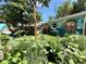Backyard with a whimsical mural on the building and a hammock, surrounded by lush greenery at 1341 Chester St, Aurora, CO 80010