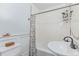 Stylish bathroom features subway tile, modern sink, and tub with floral curtain at 1341 Chester St, Aurora, CO 80010