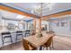 Open-concept kitchen and dining area with a large dining table and bar seating at 1341 Chester St, Aurora, CO 80010