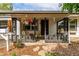 Charming covered front porch with decorative hanging planters and a gray railing at 1341 Chester St, Aurora, CO 80010