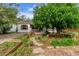Beautiful landscaping with raised garden beds, a stone path, and a mature tree at 1341 Chester St, Aurora, CO 80010