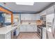 Contemporary kitchen with white cabinetry, stainless steel appliances, and stylish backsplash at 1341 Chester St, Aurora, CO 80010