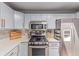 Well-appointed kitchen featuring stainless steel appliances, stylish backsplash, and ample counter space at 1341 Chester St, Aurora, CO 80010