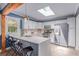 Modern kitchen with white cabinets, stainless steel appliances, and a skylight at 1341 Chester St, Aurora, CO 80010