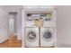 Well-equipped laundry room with modern washer and dryer, plus built-in shelving at 1341 Chester St, Aurora, CO 80010
