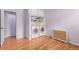 Bright laundry room with washer, dryer, hardwood floors, and storage shelves at 1341 Chester St, Aurora, CO 80010