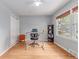 Bright office space with hardwood floors, a large window, and a modern adjustable-height desk at 1341 Chester St, Aurora, CO 80010