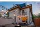 Inviting backyard with patio, string lights, fire pit, and outdoor dining area for relaxing and entertaining at 3845 N Raleigh St, Denver, CO 80212