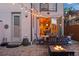 Outdoor patio with string lights, fire pit, and seating area, creating a cozy backyard ambiance at 3845 N Raleigh St, Denver, CO 80212