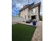 Backyard featuring artificial turf, stone patio with outdoor seating, fire pit, and string lights at 3845 N Raleigh St, Denver, CO 80212