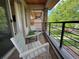 Cozy balcony with brick flooring, metal railings, and outdoor seating overlooking the neighborhood at 3845 N Raleigh St, Denver, CO 80212