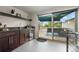 Stylish bar area with dark cabinets, a wine fridge, and sliding doors opening to a rooftop patio at 3845 N Raleigh St, Denver, CO 80212
