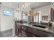 Modern bathroom featuring dual sinks, granite countertops, updated fixtures, and a glass-enclosed shower at 3845 N Raleigh St, Denver, CO 80212