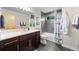 Well-lit bathroom with modern vanity, tiled shower-tub combination, and stylish decor at 3845 N Raleigh St, Denver, CO 80212
