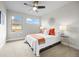 Cozy bedroom featuring a white bed, ceiling fan, and two windows, filled with natural light at 3845 N Raleigh St, Denver, CO 80212