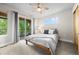Bright bedroom with ceiling fan, balcony access with outdoor seating, and neutral decor at 3845 N Raleigh St, Denver, CO 80212