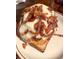 Breakfast menu item served with cheese and bacon on top of toast at 3845 N Raleigh St, Denver, CO 80212