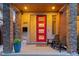 Welcoming front entrance with a red door, decorative stone columns, and a stylish porch at 3845 N Raleigh St, Denver, CO 80212