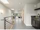 Hallway leading to a bar area and a living room, featuring modern lighting and tiled floors at 3845 N Raleigh St, Denver, CO 80212