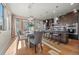 Open-concept kitchen and dining area featuring hardwood floors, stylish pendant lighting, and a modern dining table at 3845 N Raleigh St, Denver, CO 80212