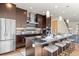 Modern kitchen with stainless steel appliances, a center island with seating, and dark wood cabinetry at 3845 N Raleigh St, Denver, CO 80212