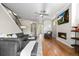 Open living area with a modern fireplace, mounted TV, hardwood floors, and an open layout, filled with natural light at 3845 N Raleigh St, Denver, CO 80212
