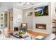 Living room featuring a sleek fireplace, a modern ceiling fan, hardwood floors, and contemporary décor at 3845 N Raleigh St, Denver, CO 80212