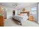 Spacious main bedroom with a wooden headboard, ceiling fan, walk-in closet, and large windows at 3845 N Raleigh St, Denver, CO 80212