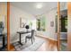 Bright home office space with modern desk, chair, neutral decor and a window overlooking lush greenery at 3845 N Raleigh St, Denver, CO 80212