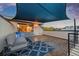 Inviting rooftop patio with comfortable seating and a shade covering, perfect for outdoor relaxation at 3845 N Raleigh St, Denver, CO 80212