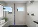 Contemporary shower featuring a glass enclosure, rain showerhead, built-in bench, and sleek tile work at 3845 N Raleigh St, Denver, CO 80212