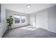 Bright bedroom featuring neutral walls, carpet flooring, and two sunlit windows at 17127 Lark Water Ln # D, Parker, CO 80134