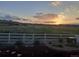 Backyard view featuring a grassy field with a sunset at 6070 Long Branch Dr, Parker, CO 80134