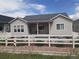 Backyard with patio and grassy area beyond a decorative fence at 6070 Long Branch Dr, Parker, CO 80134