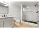 Modern bathroom featuring marble shower, black fixtures, and a white vanity at 6070 Long Branch Dr, Parker, CO 80134