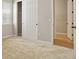 Carpeted bedroom featuring a closet with sliding doors and a doorway to a closet at 6070 Long Branch Dr, Parker, CO 80134