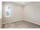 A well lit bedroom with light colored carpet and a view out of the window at 6070 Long Branch Dr, Parker, CO 80134